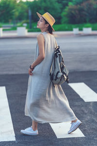 Low section of woman standing on road