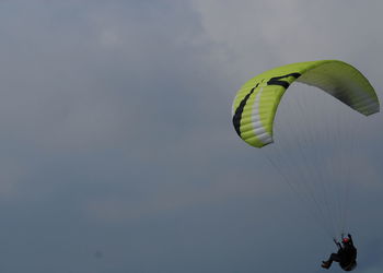 Person paragliding against sky