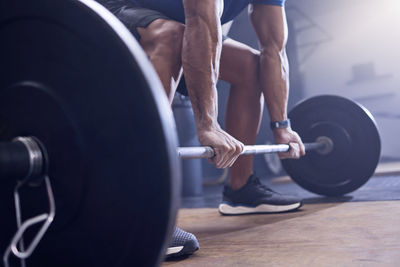 Midsection of man exercising in gym