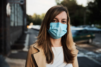 Woman in protective mask at city street