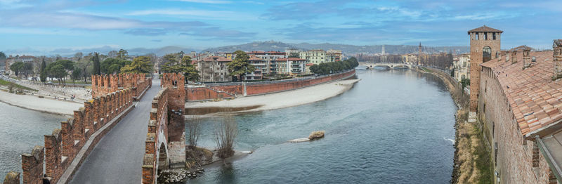 Extra wide angle view of the adige river, the panorama of verona and the castelvecchio bridge
