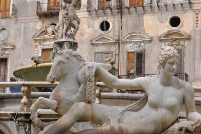 Statue against historic building