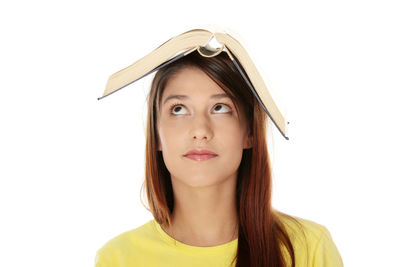 Portrait of beautiful young woman against white background