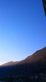 Scenic view of mountains against clear blue sky