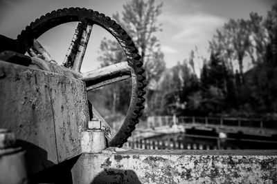 Close-up of rusty chain on bridge against sky