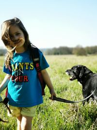 Woman with dog on field against sky