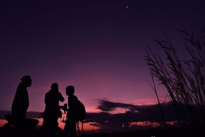 Silhouette man standing against sky during sunset