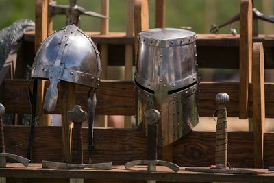 Knight helmets with swords on railing