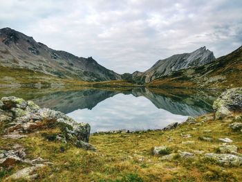 Scenic view of lake and mountains against sky