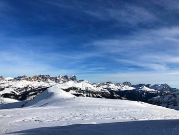 Snow covered mountains against blue sky