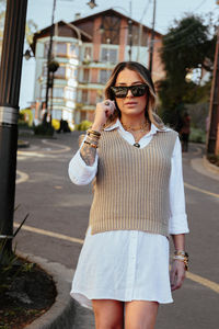 Young woman wearing sunglasses standing outdoors