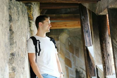 Smiling man standing against wall