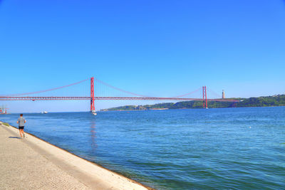 View of suspension bridge over sea