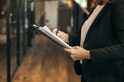 Midsection of woman using mobile phone