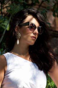 Close-up of beautiful young woman wearing sunglasses