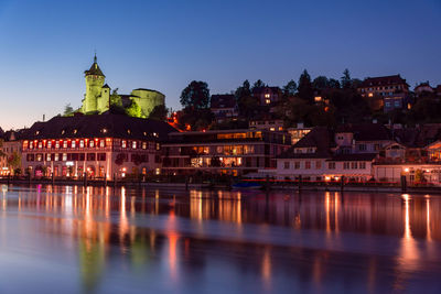 Illuminated buildings at waterfront