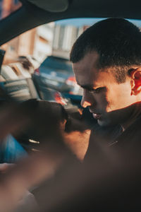 Multiple image of man sitting in car