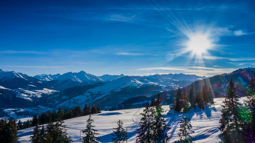 Aerial view winter wonderland in the alps with mountain chalet at sunset switzerland 