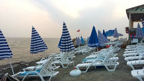 View of umbrellas on beach against sky