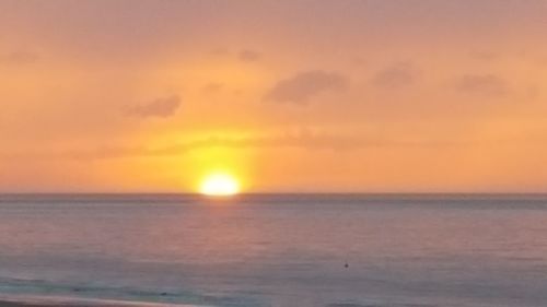 View of calm sea at sunset