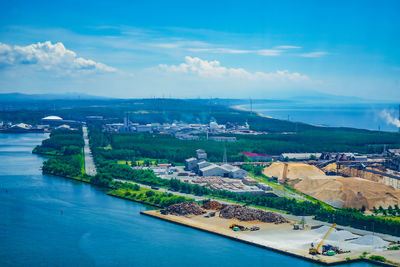 High angle view of townscape by sea against sky