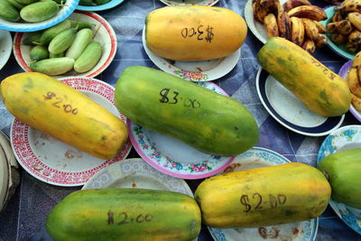 High angle view of price written on papayas for sale at market