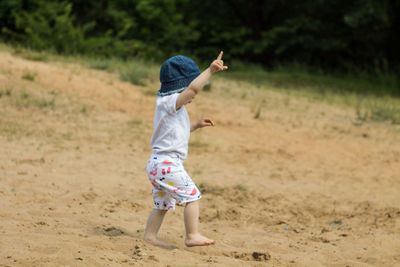 Boy standing on sand