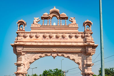 Artistic temple entrance gate with bright blue sky at morning from flat angle