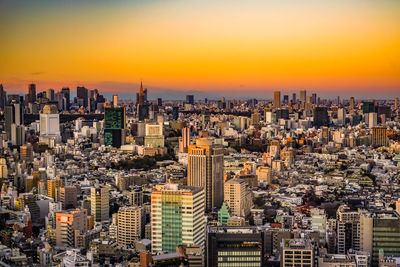 Aerial view of cityscape against sky during sunset