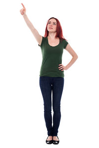 Portrait of young woman standing against white background