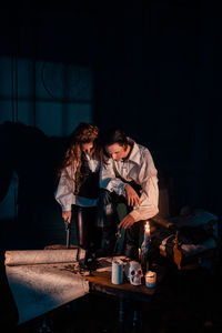 Young couple sitting on table at night