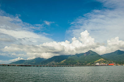 Overview of sea, mountain landscape of ilhabela island, port and ships in são sebastião, brazil