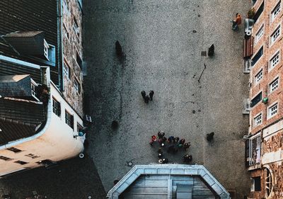 Directly above shot of people on city street amidst buildings