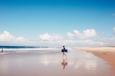 Man on beach against sky