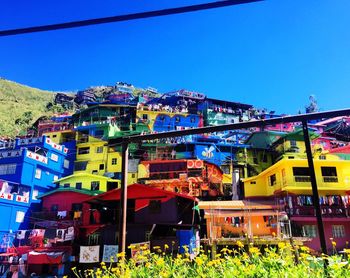 Multi colored houses against clear blue sky