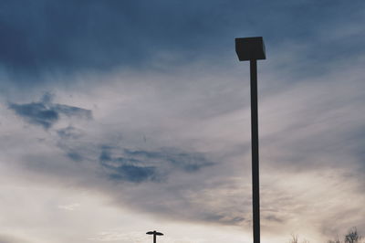 Low angle view of street light against cloudy sky