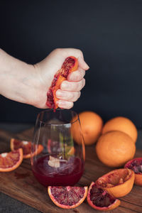 Hand squeezed blood orange juice fresh into glass