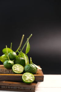 Close-up of fruits on table against black background