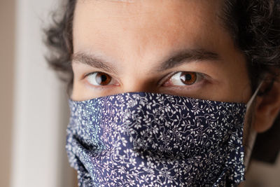 Close-up portrait of mid adult woman covering face