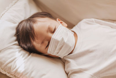 High angle view of baby sleeping on bed at home