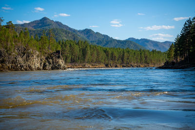 Scenic view of sea and mountains against sky