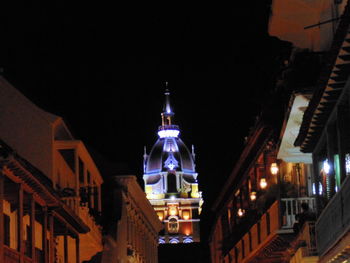 Low angle view of illuminated cathedral against sky at night