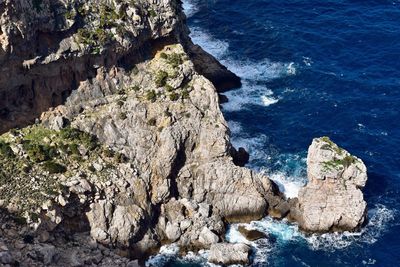 High angle view of rock formations in sea