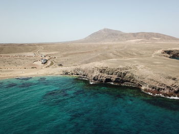 Aerial view of coastline against sky