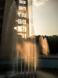 Water splashing on fountain against sky