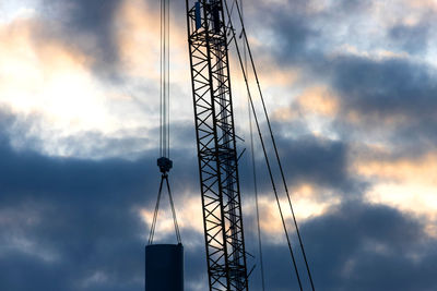 Low angle view of electricity pylon against sky