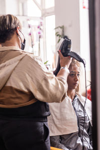 Rear view of woman photographing