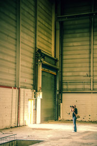 Full length of man standing in warehouse