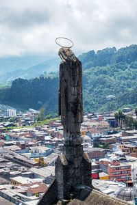 Statue on manizales cathedral in city against sky