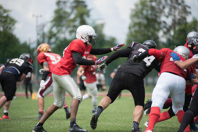 Group of people running on field